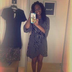 Black and white striped, knee length dress.